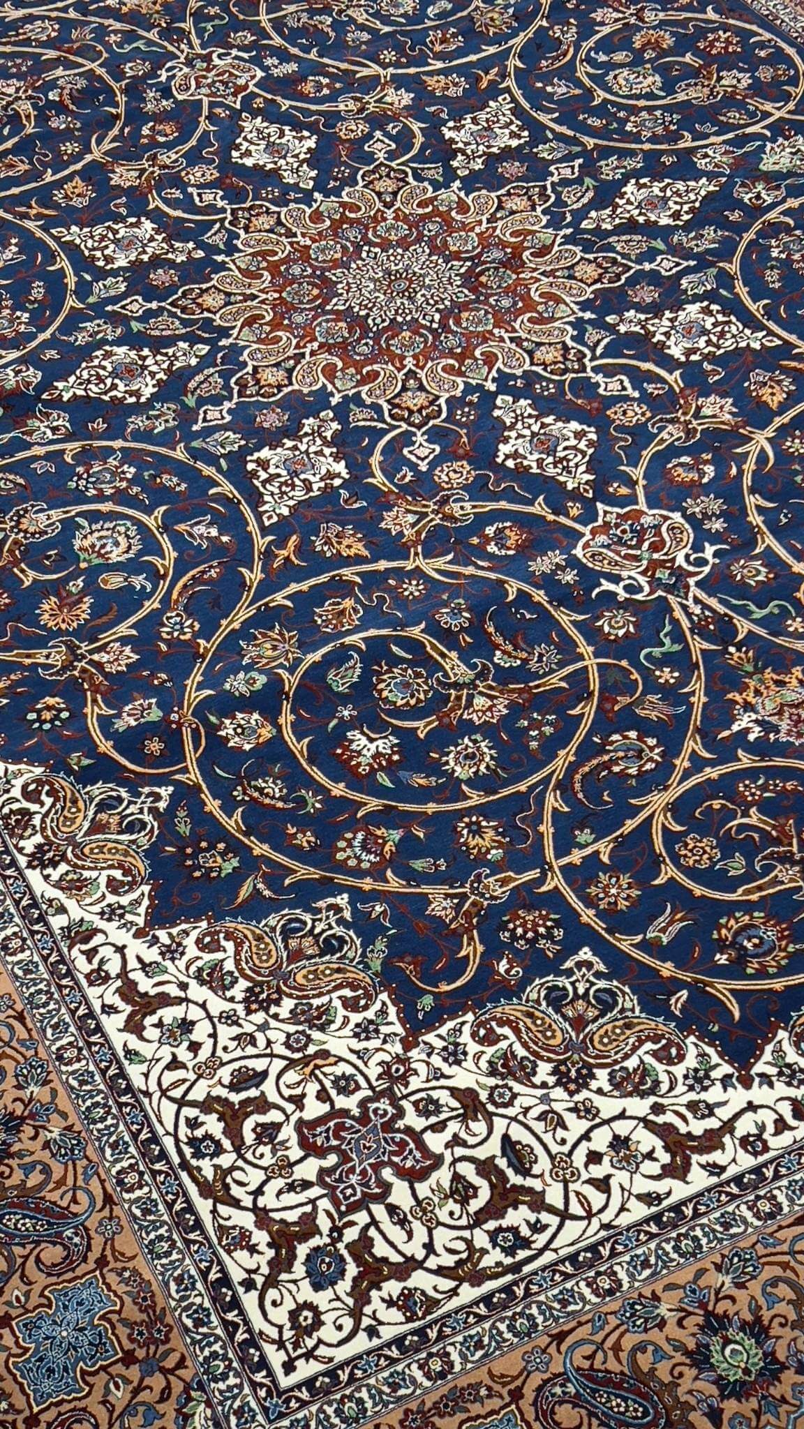 "Luxurious Persian rug showcasing a central medallion design in deep blue, ivory, and gold tones."